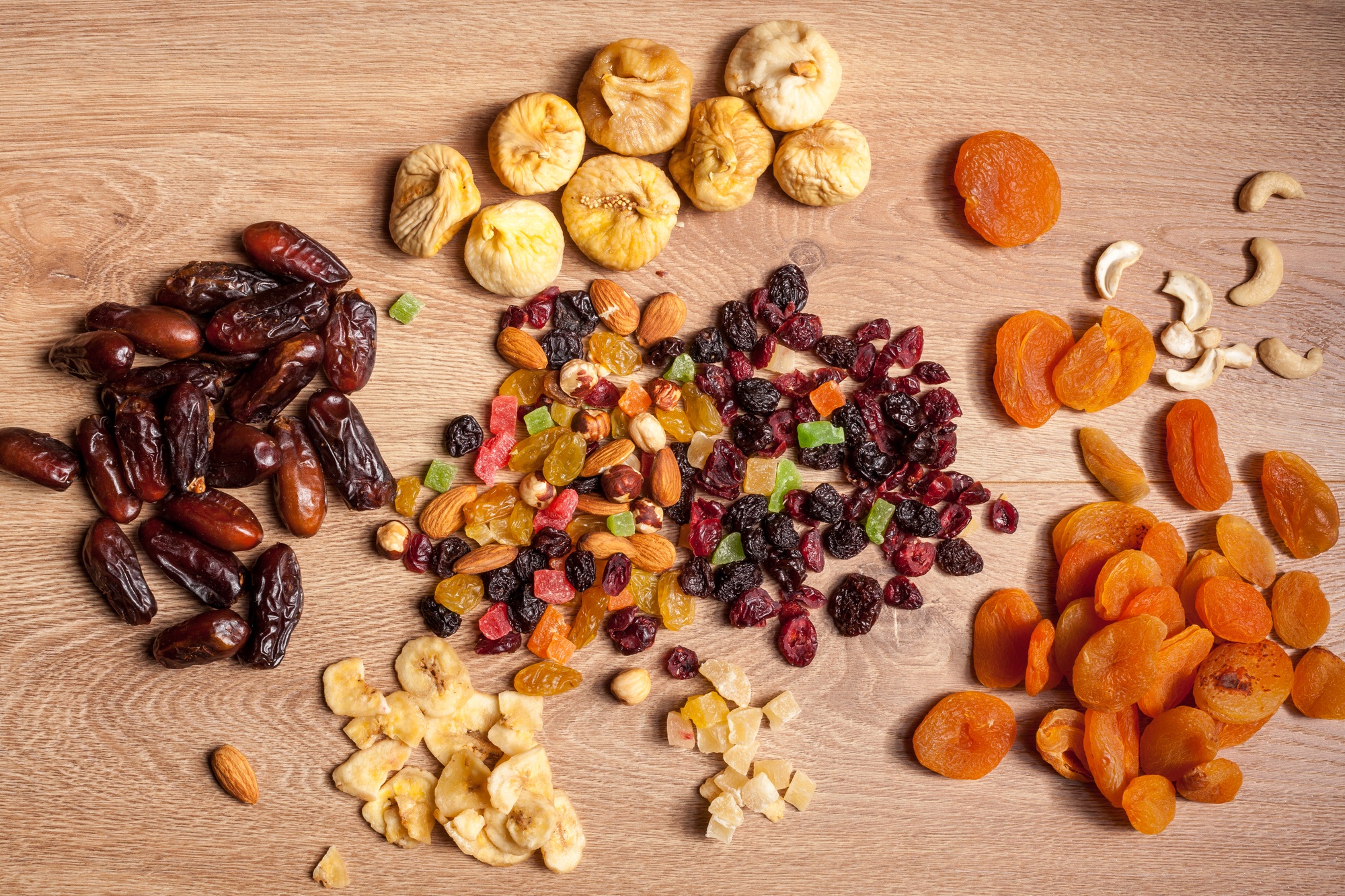 Dried fruits and nuts on wooden background